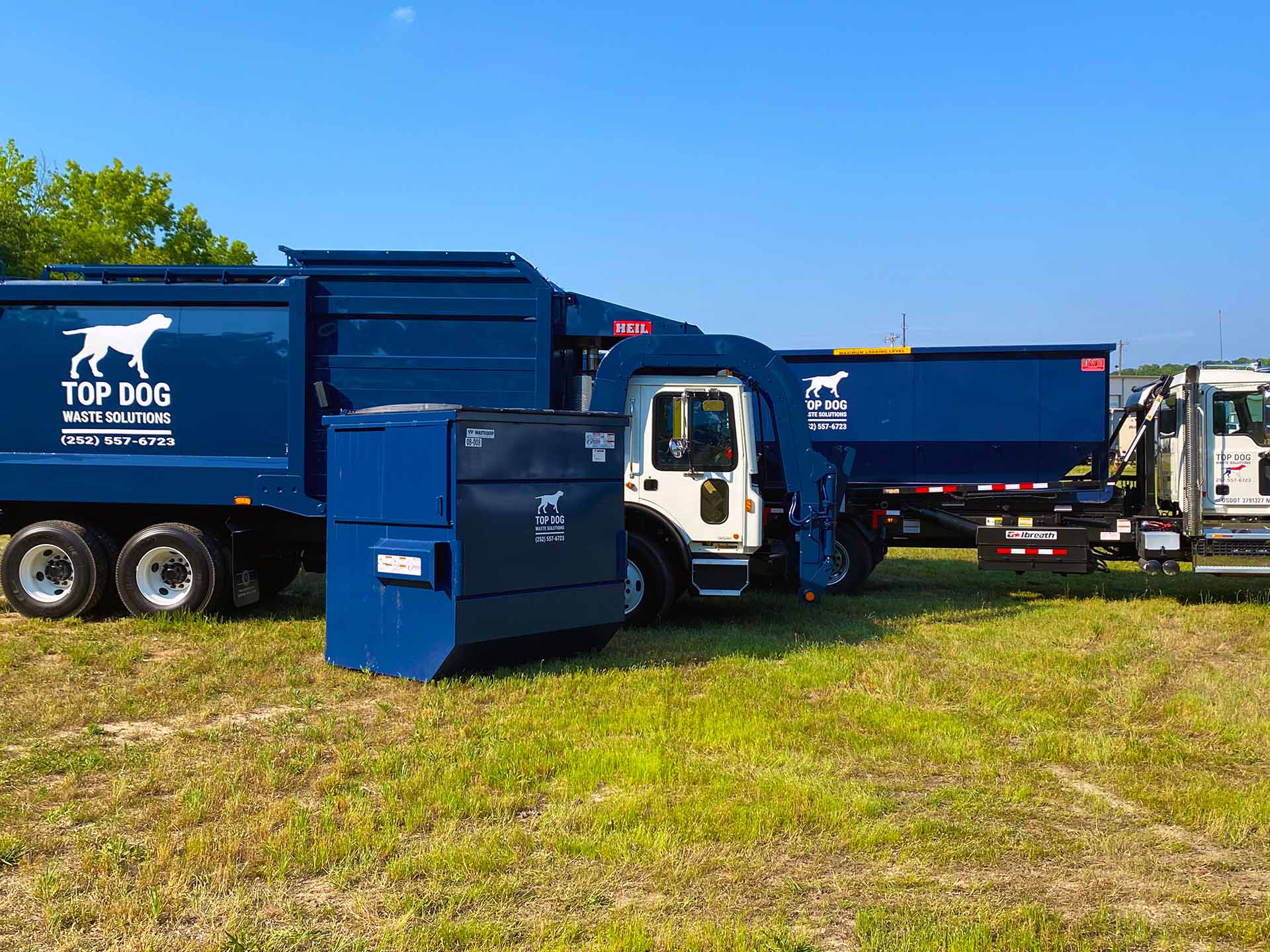 Top dog Waste Solutions trucks and front load dumpster