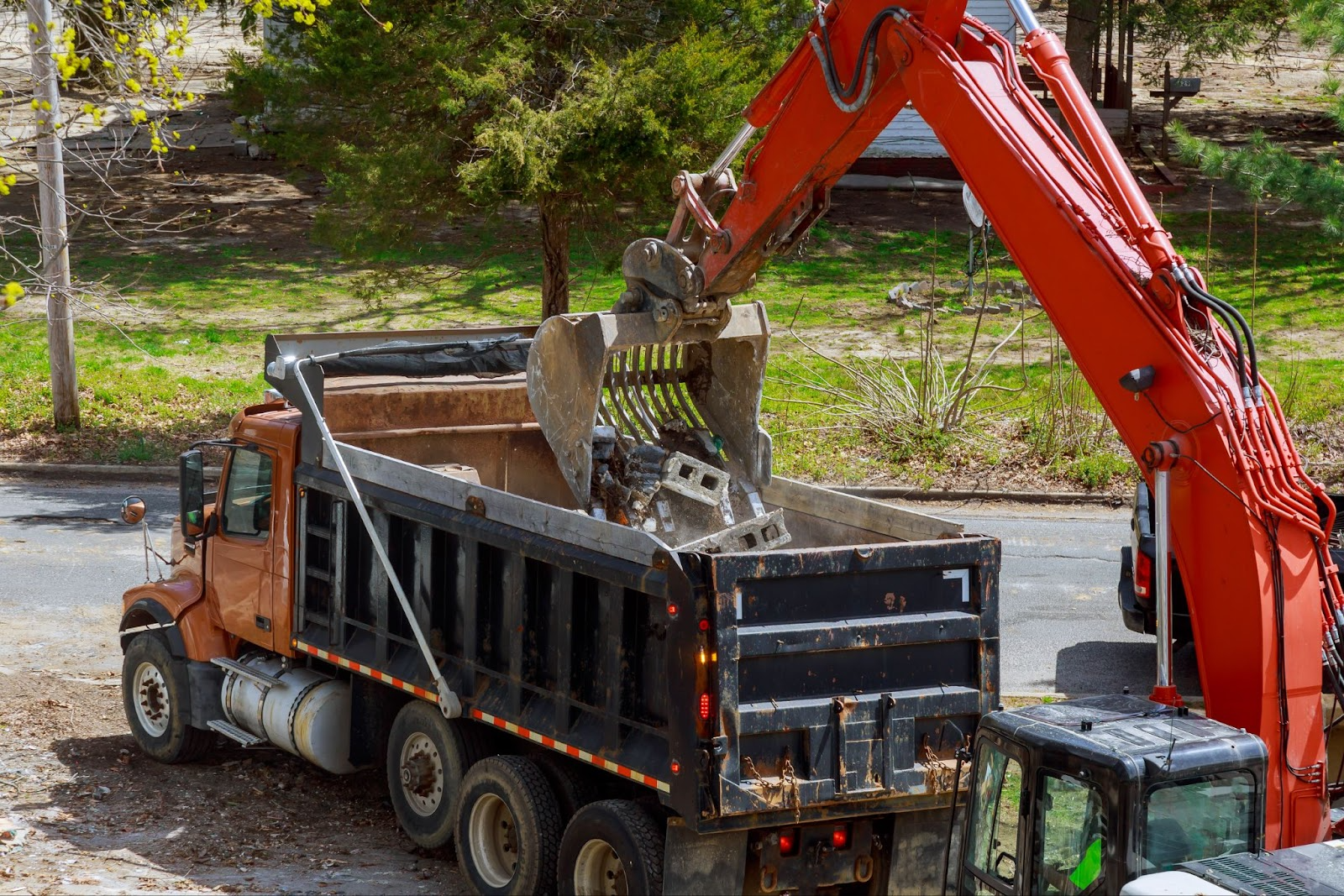 Debris being placed into the back of a truck. 