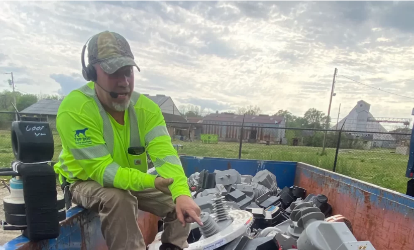 Staff going through recycled parts in a bin